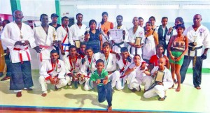 Top performers of the LDMAA international martial arts tournament strike a pose with their medals, trophies and certificates. Miss India Guyana (standing centre) shares the moment