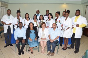 From left seated: Chief Medical Officer Dr Shamdeo Persaud; Head of the Cuban Medical Brigade in Guyana Dr Maria Del Carmen; Cuban embassy representative Praxedes Lovit Nardet; and Health Minister, Dr Bheri Ramsaran with the new doctors