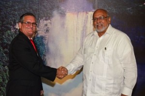 President Donald Ramotar exchanges a handshake with new Cuban Ambassador to Guyana Julio Cesar Gonzales Marchante