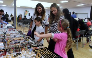 Patrons check out the jewelry offered by Pritis Fashion, a vendor at the event