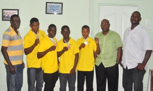 President of the Guyana Boxing Association Steve Ninvalle (second right) and Technical Director Terrence Poole (right) strike a pose with Guyana’s South American Youth Games medalists; standing second from left: Travis Fraser, Joel Williamson, Tefon Greene and Michael April, with coach Wincell Thomas at extreme left