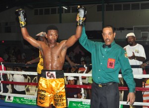 Referee Eion Jardine raises the hand of Clive “The Punisher” Atwell after his win on Sunday night