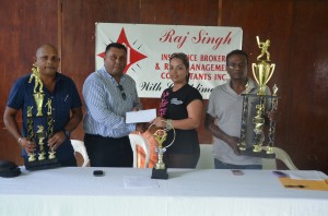 President of the DCB and proprietor of Raj Singh Insurance Brokers Raj Singh (second left) hands over the sponsorship cheque to DCB administrator Melinda Bishundyal. East Bank Demerara cricket coordinator Deonarayan Debidial (right) and DCB Marketing Manager Ray Persaud display the winner and runner-up trophies