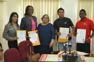 Representatives of various broadcasting entities pose with their certificates after the presentation by Guyana National Broadcasting Authority (GNBA) Chairperson Bibi Shaddick last Friday at the entity's office