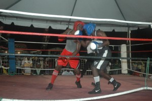 Marvin Ageday in blue trunks connects with an uppercut against William Hendricks