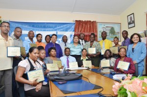 From left standing: GT&T CEO Radha Krishna Sharma (sixth), GTU President Collin Bynoe (seventh), Education Minister Priya Manickchand (eighth), Chief Education Officer Olato Sam (ninth) and GTU and GT&T officials with the teachers rewarded