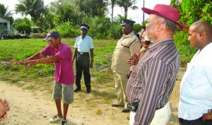 Prime Minister Samuel Hinds listening to concerns raised by an Adventure Village resident