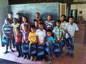 Parbaty Tejsingh (far left) with a section of primary school children who received packages of school supplies at the Nirvana Center in August