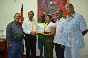 Sport Minister Dr Frank Anthony presents the cheque to GRFU secretary Nicole Nero. Sharing the moment are (from left): GRFU president Peter Green, GRFU committee member Robin Roberts, Director of Sport Neil Kumar and GRFU Match Secretary Peter Campayne