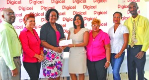 Digicel Sales and Distribution Manager Nalini Vieira presents ACHF Chairman Mignon Bowen with a cheque of an undisclosed sum to aid with breast cancer awareness activities (Avenash Ramzan photo)