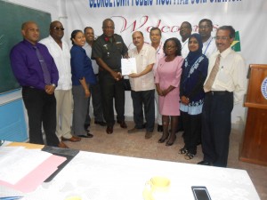 Health Minister Dr Bheri Ramsaran (sixth from left) presents the GPHC’s licence to former board chairman, Colonel Mark Phillips. Others in photo from left are Dr Mahendra Carpen, Dr Dalgleish Joseph, Renata Chuck-A-Sang, Dr Sheik Amir, GPHC Chief Executive Officer Michael Khan, Norma Semple, Kemtom Alexander, Bibi Zaheeda Hack, Dr Shamdeo Persaud and Nirmal Rekha (extreme right)