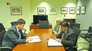 From left to right: Bulgaria’s Finance Minister Dr Petar Chobanov, Guyana’s Finance Ministry Chief Planning Officer Clyde Roopchand and Finance Minister Dr Ashni Singh signing the debt write-off agreement in the boardroom at the World Bank in Washington, DC 