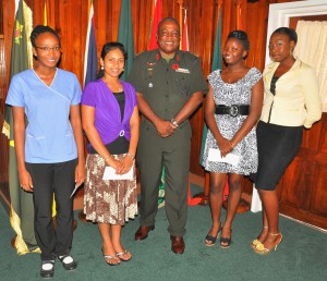 The proud awardees pose with Army Chief-of-Staff, Brigadier Mark Phillips (centre) following the presentation. From left: Maya Phillips, Roopa Seenarine, Belinda Bess, and Crystal Crawford