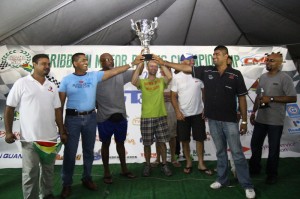 Some members of team Guyana pose with the championship trophy after copping the country title at the 2013 Seaboard Marine CMRC (Photos: Rohindra Mahase)