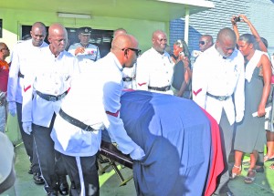 Policemen remove the body of slain TSU rank Michael Forde from the First Assembly of God Church, D’Urban Street, Georgetown following an emotional funeral service