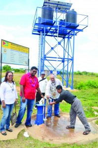 President Donald Ramotar pumps water for residents to wash their hands from the recently commissioned Kwatamang Well in the presence of Housing and Water Minister Irfaan Ali and Amerindian Affairs Minister Pauline Sukhai