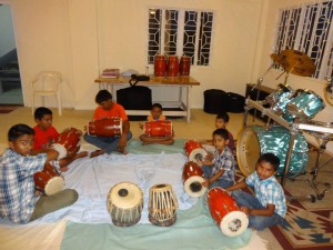 Students learning to play the dholak