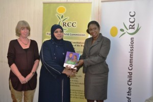 Rights of the Child Commission Chairperson Aleema Nasir, in the company of UNICEF Representative for Guyana and Suriname Marianne Flach (left), presents Human Services and Social Security Minister Jenifer Webster with copies of the three booklets