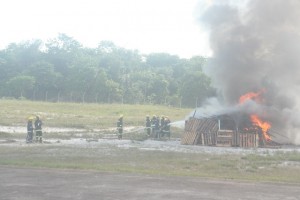 Guyana Fire Service ranks putting out the fire at the simulated crash site