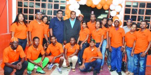 Housing and Water Minister Irfaan Ali and the new store’s owner Rajendra Maye, surrounded by a number of employees at the opening of the new store 