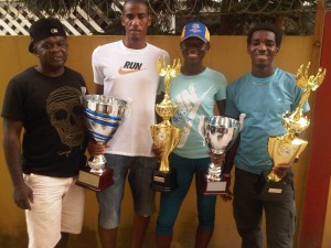 Top performers! From left: coach Leslie Black, Lionel D’Andrade, Alika Morgan and Kelvin Johnson pose with their trophies