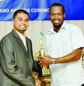 Trevon Garraway (right) receives his award from a representative of the OSCL