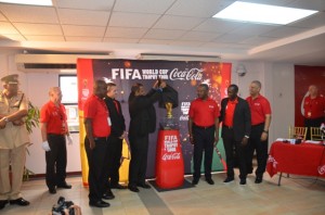 Historic moment:  Sport Minister Dr Frank Anthony unveils the original FIFA World Cup trophy at the Cheddi Jagan International Airport on Wednesday.  The solid gold trophy was on a one-day visit to Guyana as part of a nine-month, 89-country tour across the globe, before it heads back to the host country for the 2014 FIFA World Cup - Brazil.