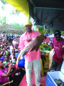 A participant in the fish festival holds up part of his catch  