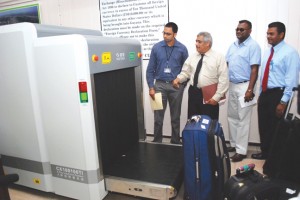 GRA Commissioner General Khurshid Sattaur (second from left) shares a word with CJIA Chief Executive Officer Ramesh Ghir (right) as they observe the baggage scanner at work (file photo)