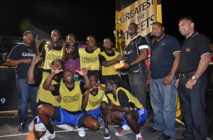 Guinness Brand Manager, Lee Baptiste, presents the championship trophy and cash incentive to members of the Queen Street-Tiger Bay team in the presence of other officials of Banks DIH Limited and the Petra Organisation (Photos: Avenash Ramzan)