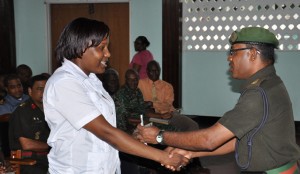 Lance Corporal Onika Emanuel receives her incentive from Lieutenant Colonel Ramkaran Doodnauth