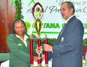 June Ogle collects the Female Cricketer-of-the-Year trophy from Director of the West Indies Cricket Board (WICB), Baldath Mahabir