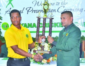 GCB Secretary and WICB Director, Anand Sanasie hands over the Cricketer-of-the-Year trophy to Leon Johnson  (Photos: Rajiv Bisnauth)