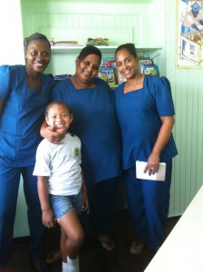 Headmistress Andrea Hutson, center, with two teachers and a student at the school