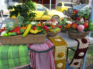 Home decor such as fruit baskets and knitted kitchen towels by artist Patricia Helwig are sold at affordable prices at the Christmas Village