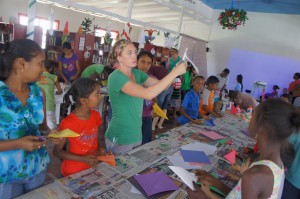 Volunteers teaching the children basic art skills