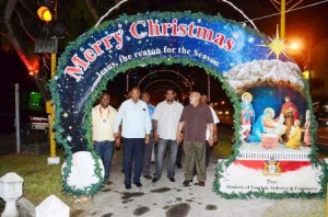 President Donald Ramotar (right) and acting Tourism Minister Irfaan Ali (third left) with other officials inspect the preparations for the opening of the Christmas Village on Main Street, Georgetown on Friday