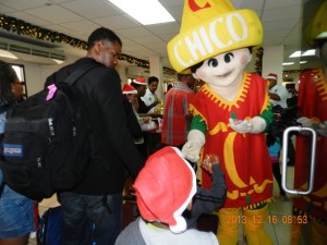 A passenger samples one of Edward Beharry’s products under the merry gaze of the Chico man