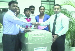 The Guyana Bank for Trade and Industry (GBTI) donates several bins to the Port Mourant Primary School at the commissioning of its branch in Port Mourant on Saturday