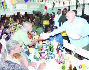 President Donald Ramotar serving soldiers at the Christmas luncheon at Base Camp Ayanganna