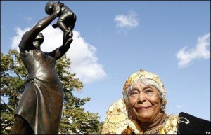 Cecile Nobrega in front of the Bronze Woman statue at its October 2008 unveiling