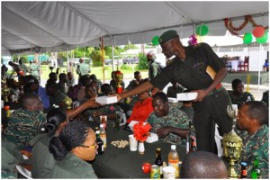 At Base Camp Stephenson, Base Commander Lieutenant Colonel Wilbert Lee serves lunch to the troops