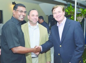 U.S. Ambassador D Brent Hardt shaking hands with Chief Medical Officer Dr Shamdeo Persaud in the presence of Howard University Hospital Medical Association Chairman Phillip H Omohundro 