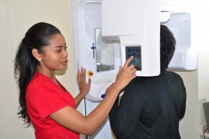 Using state-of-the-art dental equipment to care for her patients at Dr. Sen Gupta and Associates clinic