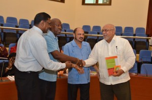 President Donald Ramotar receives a copy of Health Vision 2020 from CMO Dr Shamdeo Persaud, Health Minister Bheri Ramsaran and Health Ministry Permanent Secretary Leslie Cadogan