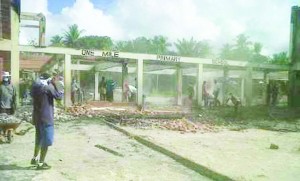 Residents clearing the burnt-out site of the One Mile Primary School in Linden during the early stages of the rebuilding efforts