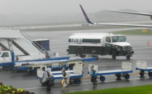 Passengers navigate their way to the Immigration Department at the CJIA on a rainy day