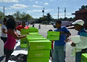 Volunteers handing out boxes of shoes