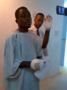 The tortured teen showing his bandaged hands while speaking to media operatives in the Burns Care Unit on Tuesday