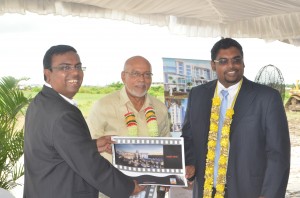 President Donald Ramotar and acting Tourism Minister Irfaan Ali being presented with a copy of the hotel plan